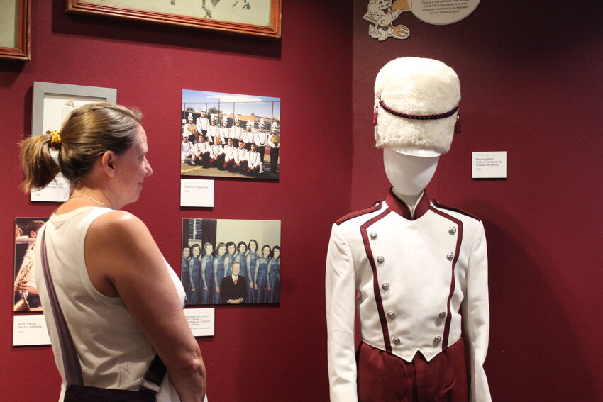 A Golden History Museum visitor examines a 1990s Golden High School marching band uniform during the Aug. 24 exhibit opening. The new exhibit, which gives a general overview of GHS' 150-year history, will run for at least a year.